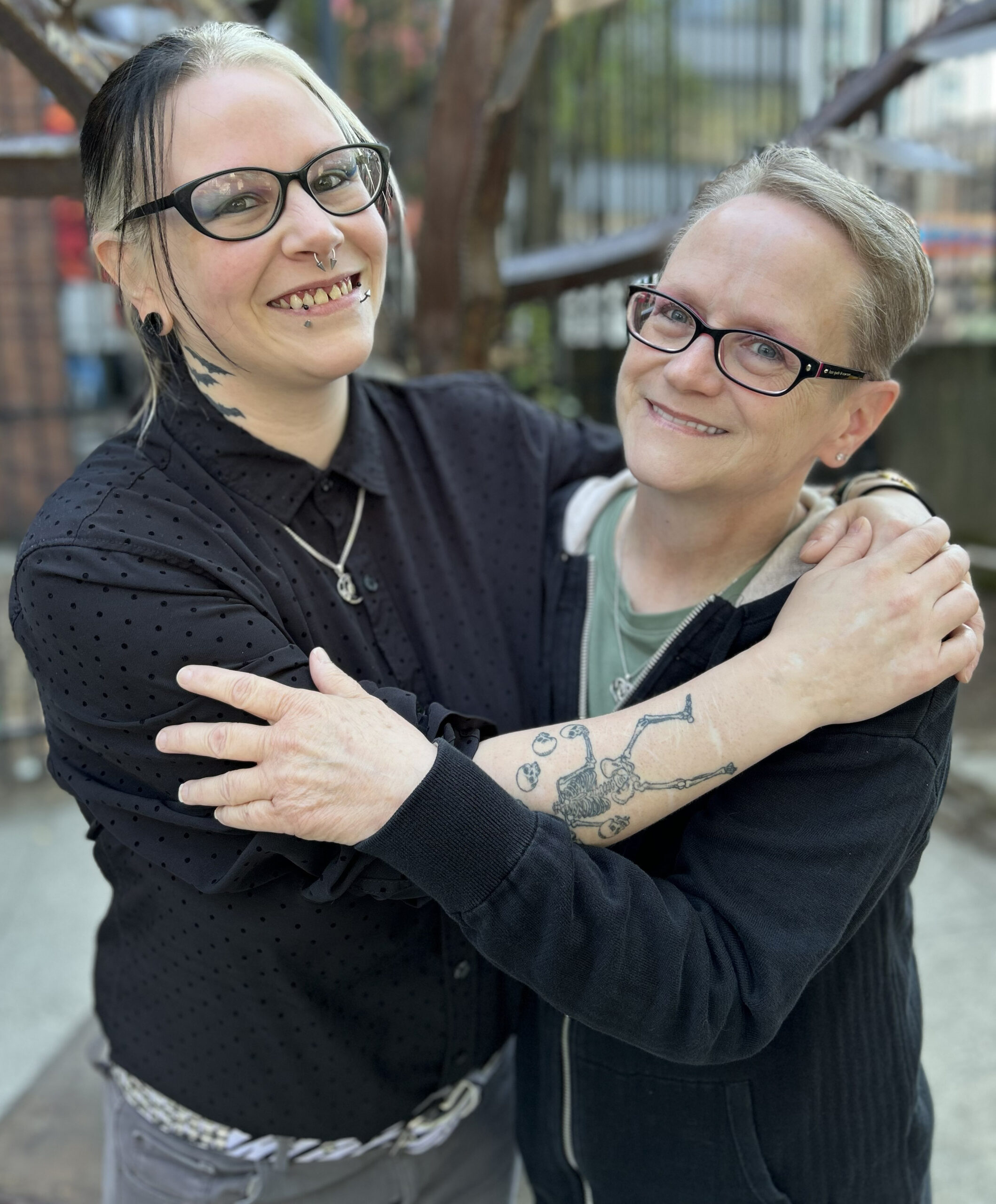 Medical Assistants Becca, left, and Beverley embrace in the Outside In courtyard. They Becca is a daughter of Beverley.