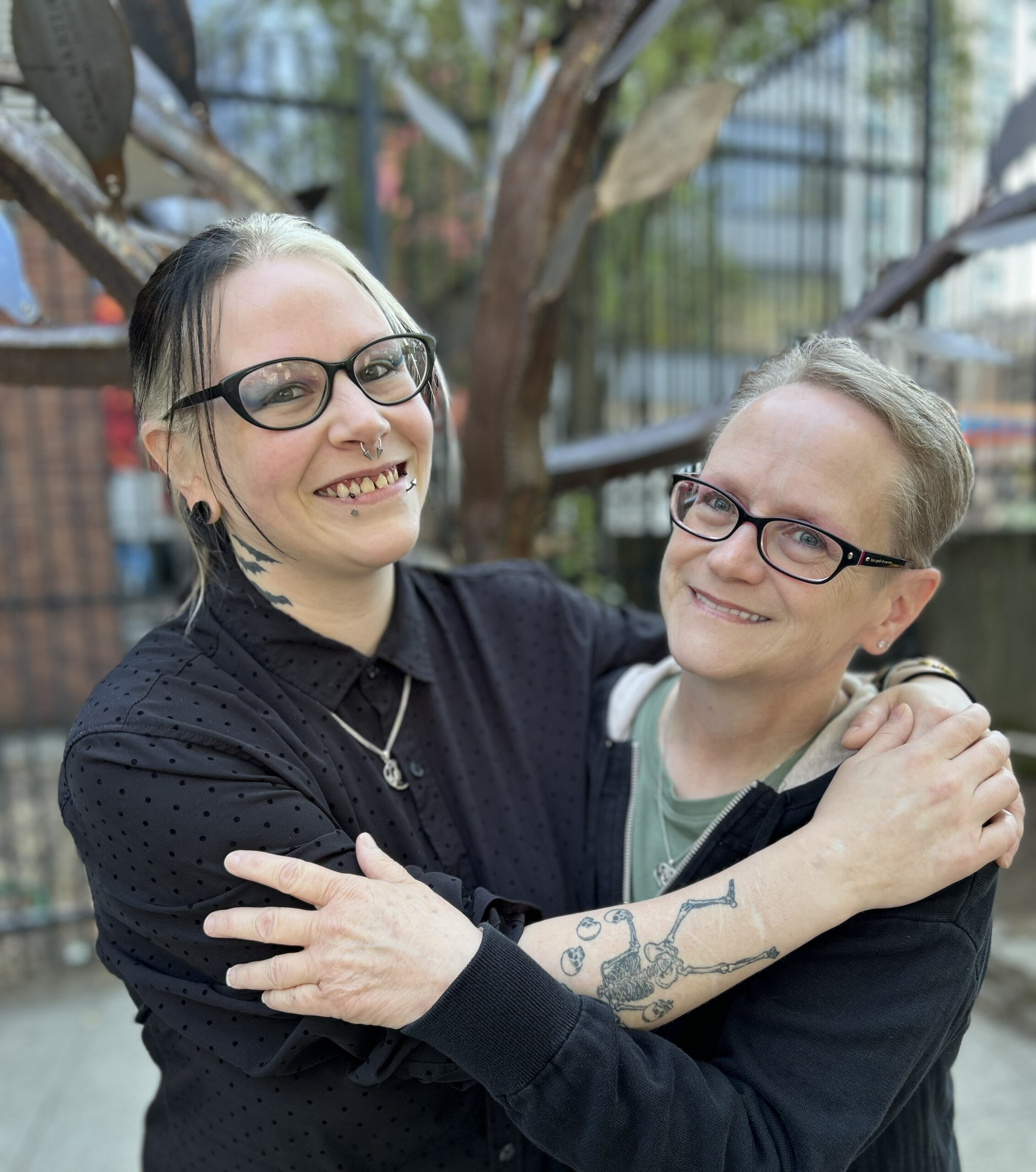 Medical Assistants Becca and Beverley embrace as mother and daughter.